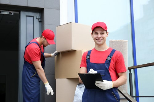 Workers loading mixed household waste into a van from a flat above a shop
